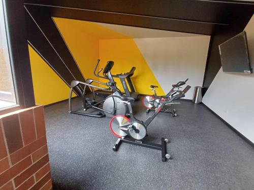 a gym with three exercise bikes in a room at 804 Loft Estilo Industrial NY in Guatemala