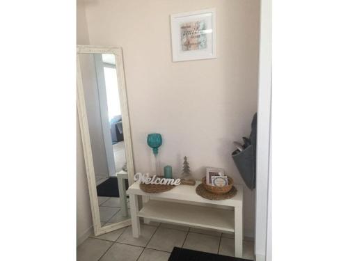 a bathroom with a mirror and a dressing table at Bungalow at Galgenberg in Wernigerode in Wernigerode