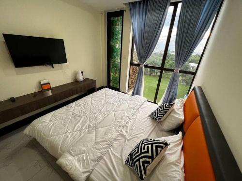 a bedroom with a bed and a tv and a window at Orkide Condo in Phnom Penh