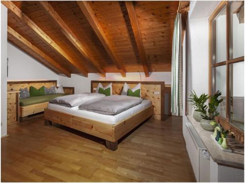 1 dormitorio con 2 camas y techo de madera en Angerer-the holiday apartment en Berchtesgaden