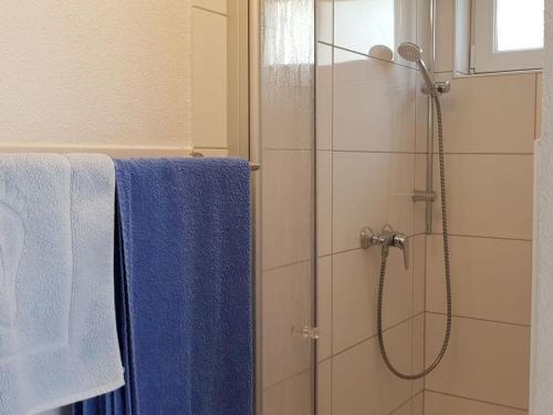 a bathroom with a shower with blue towels at Palatinate Forest Comfortable holiday residence in Silz