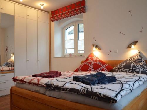 a bedroom with a bed with two bags on it at Siam Comfortable Holiday Residence in Borkum