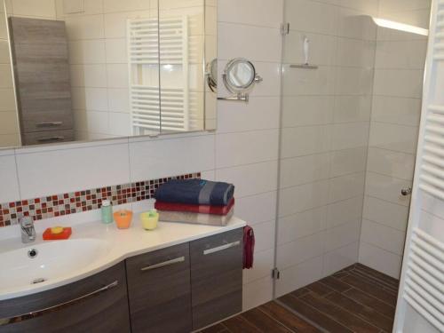 a bathroom with a sink and a shower at Siam Comfortable Holiday Residence in Borkum