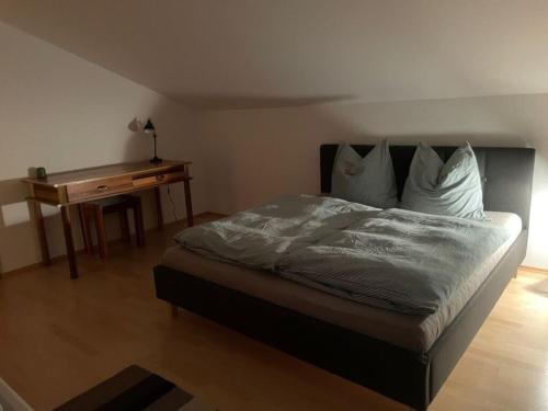 a bedroom with a bed and a wooden table at Chalet Salzeder Modern retreat in Bayerisch Gmain