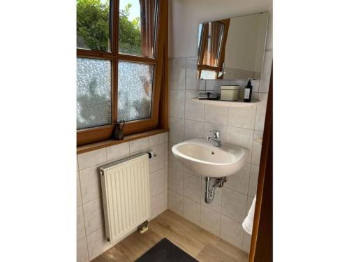 a bathroom with a sink and a window at Chalet Salzeder Modern retreat in Bayerisch Gmain