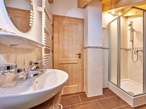 a bathroom with a sink and a shower at Holiday apartment Zugspitze in Krün