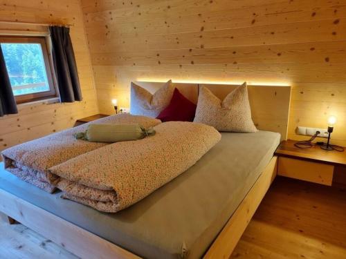 a bedroom with a large bed in a cabin at Englhof Modern retreat in Corvara in Passiria