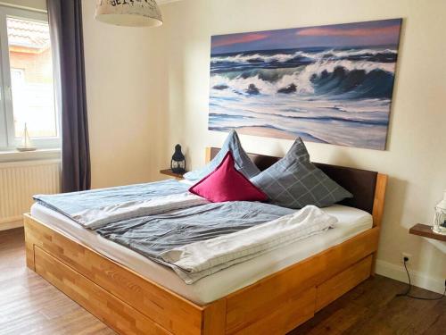 a bedroom with a bed with a painting on the wall at Colorful Cow Modern Retreat in Borkum