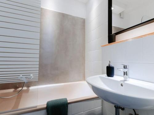 a bathroom with a sink and a bath tub and a sink at Granetal Quarter apartment Bocksberg in Goslar