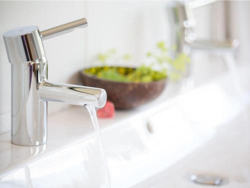 a sink with water coming out of a faucet at Platzl in the sacristan's house in Lenggries