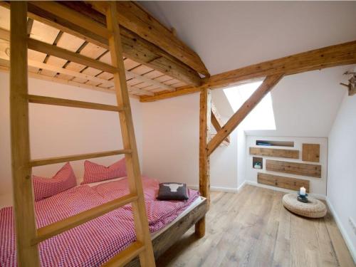 a bedroom with a bunk bed with a ladder at Platzl in the sacristan's house in Lenggries