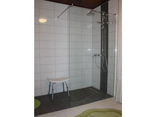 a shower with a stool in a bathroom at "At the Mühlenbachaue" in Nettetal
