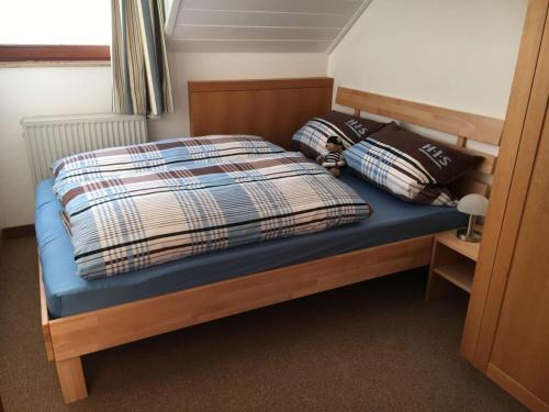 a bed with two pillows on it in a room at Postwiese Modern retreat in Winterberg