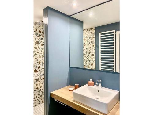 a bathroom with a sink and a mirror at Bustards Modern retreat in Birresborn