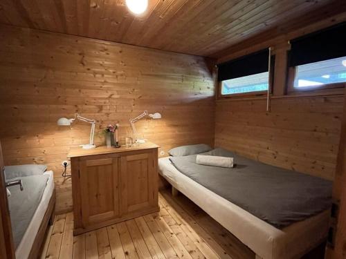 a bedroom with a bed and a desk with two lamps at Schlechtbach sawmill in Gschwend