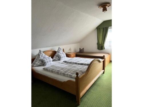 a bedroom with two beds and a green carpet at Oberrain in the Ferienhaus Schenk 