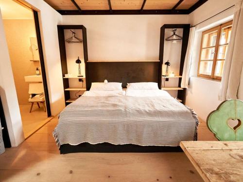 a bedroom with a large bed in a room at Grassau washhouse in Grassau