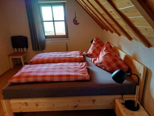 a bedroom with two beds and a window at Eisenmann holiday farm in Gengenbach