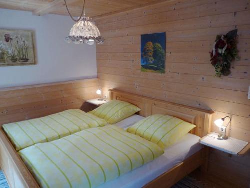 a bedroom with two beds in a wooden wall at Hirschbichler Modern retreat in Berchtesgaden