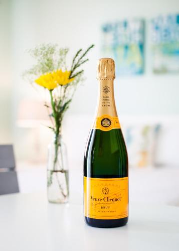 a bottle of champagne next to a vase of flowers at Sunset Inn and Cabanas in St. Pete Beach