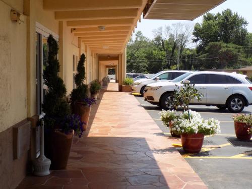 a walkway outside of a building with potted plants at Virginia Inn in Lawrence