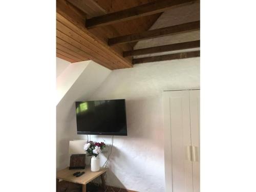 a living room with a tv on the wall at Apartment in the Schildesch town center in Bielefeld