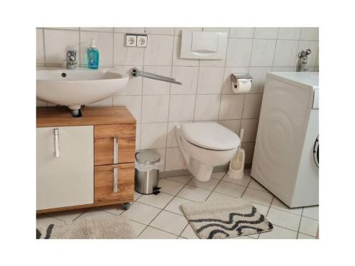 a bathroom with a white toilet and a sink at in Schambach Comfortable holiday residence in Eichstetten