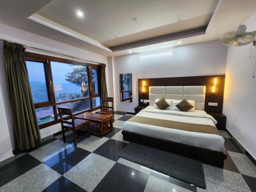 a bedroom with a large bed and a large window at The White House in Shimla