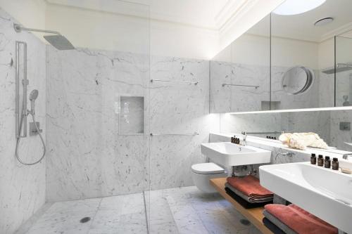 a white bathroom with a sink and a toilet at Garden Terrace in Surry Hills in Sydney