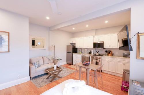 a kitchen and living room with a couch and a table at Sunny,cozy,near Bc,bu,boston,mbta in Boston