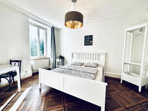 a bedroom with a white bed and a table at Business Apartment in Derendingen in Derendingen
