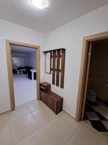 a living room with a table and a room with a couch at Belveder Montenegro in Rafailovici