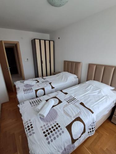 two beds sitting next to each other in a room at Belveder Montenegro in Rafailovici