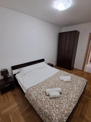 a bedroom with a bed with two towels on it at Belveder Montenegro in Rafailovici