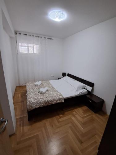 a bedroom with a bed and a wooden floor at Belveder Montenegro in Rafailovici