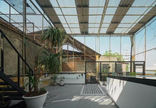 a large room with potted plants in a building at Stupid Stay in Bangkok