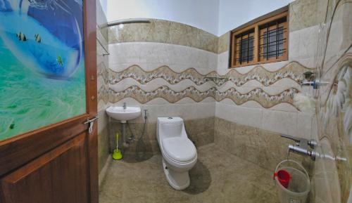 a bathroom with a toilet and a sink at Meadow Heaven Home Stay in Munnar