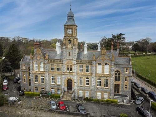 an old building with a clock tower on top of it at Luxury 1 Bedroom Duplex with Free Parking in Plymouth