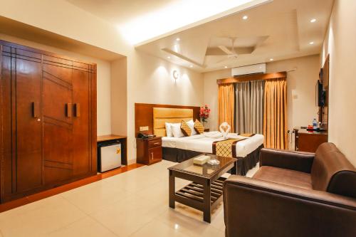 a hotel room with a bed and a couch at Hotel Central Inn & Spa in Dhaka