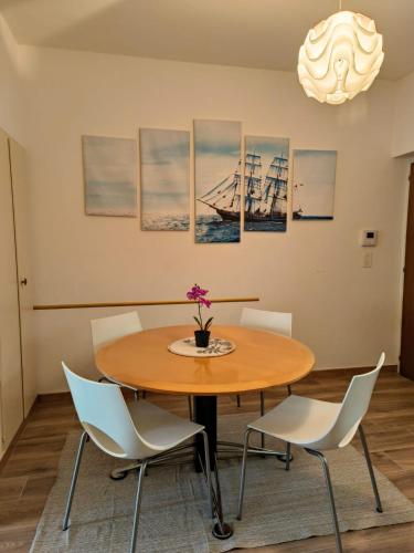a dining room with a wooden table and chairs at Sailing Apartment Lugano in Lugano