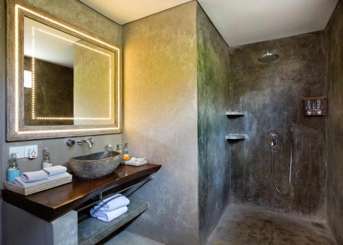 a bathroom with a sink and a shower at Blue Karma Dijiwa Seminyak in Seminyak