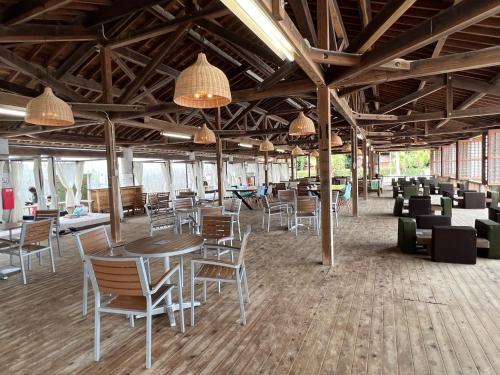 a large room with tables and chairs and lights at Iojima BeachHouse - Vacation STAY 97622v in Nagasaki