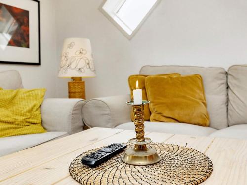 a candle on a table in a living room at 4 person holiday home in Ålbæk-By Traum in Ålbæk