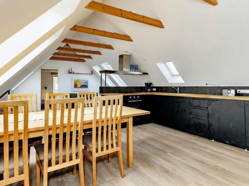 a kitchen and dining room with a wooden table and chairs at 5 person holiday home in Ålbæk-By Traum in Ålbæk