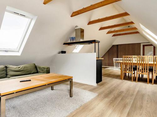 a living room with a couch and a table at 5 person holiday home in Ålbæk-By Traum in Ålbæk