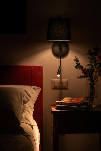 a bedroom with a bed and a table with a lamp at La casa di Benedetta in Polignano a Mare