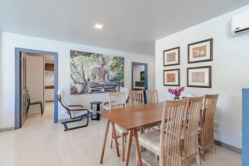 a dining room with a table and chairs at Kamala Beach Estate Resort - SHA Extra Plus in Kamala Beach
