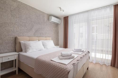 Postel nebo postele na pokoji v ubytování Kovač Family Suites