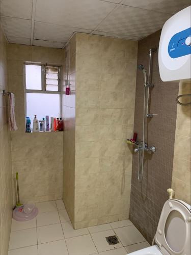 a bathroom with a shower and a toilet at Sweet Home Hattiban in Pātan