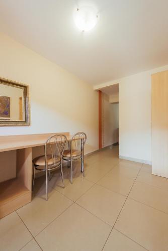 a dining room with two chairs and a table at Hotel Pod Sosnami in Osieck
